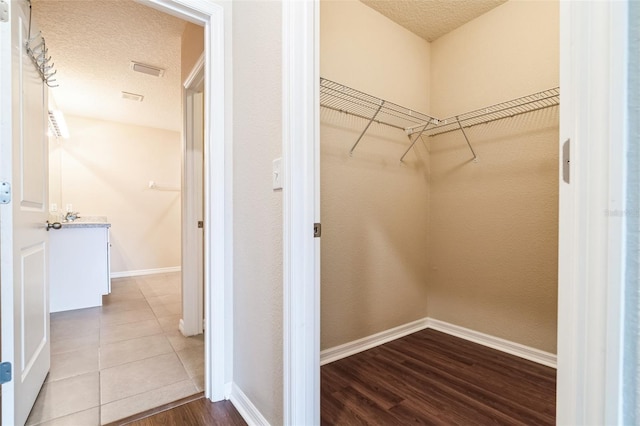 spacious closet featuring wood finished floors