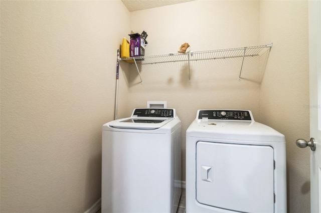 clothes washing area with laundry area and separate washer and dryer