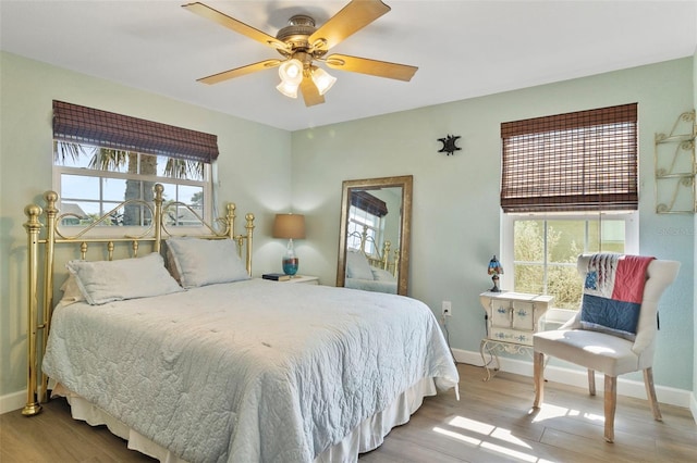 bedroom with light hardwood / wood-style flooring and ceiling fan