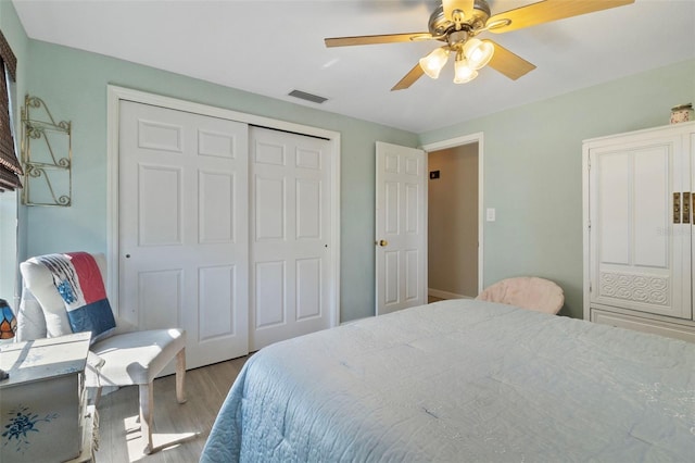 bedroom featuring a closet, ceiling fan, and light wood-type flooring