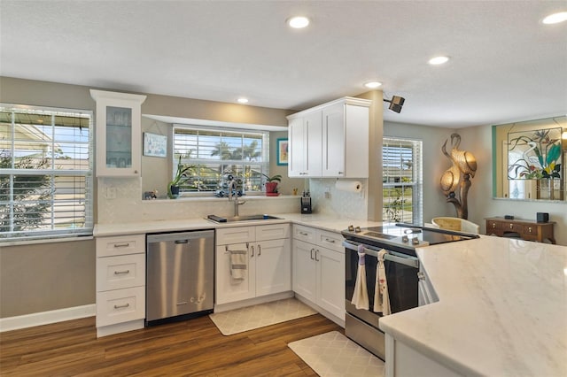 kitchen with white cabinetry, appliances with stainless steel finishes, sink, and dark wood-type flooring