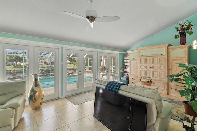 tiled living room featuring french doors, ceiling fan, and lofted ceiling