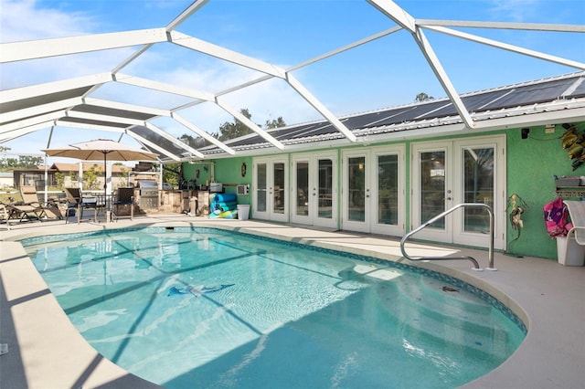 view of pool featuring a lanai, a patio area, and french doors