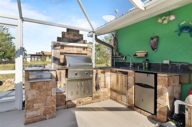 view of patio featuring exterior kitchen, area for grilling, and sink