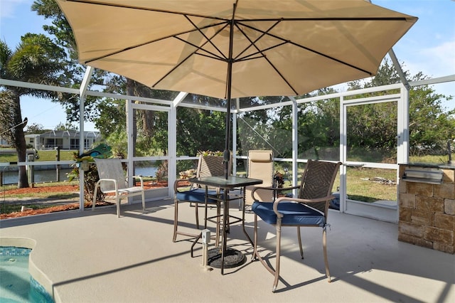 view of patio with a pool and glass enclosure