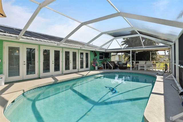 view of pool with a lanai, a patio area, and french doors