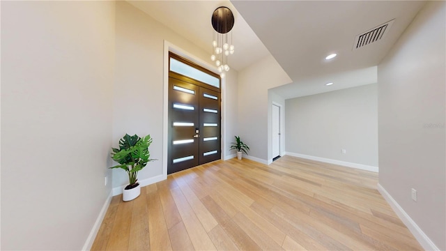 foyer entrance with recessed lighting, light wood-style floors, visible vents, and baseboards