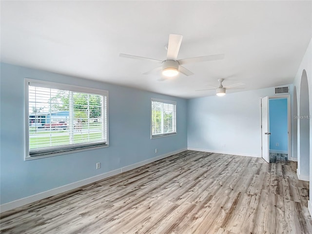 empty room with ceiling fan and light wood-type flooring