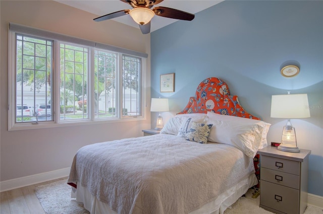 bedroom with ceiling fan and light wood-type flooring