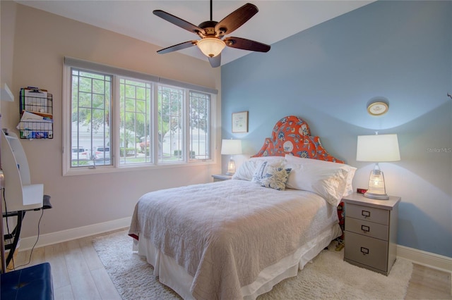 bedroom with ceiling fan and light hardwood / wood-style floors