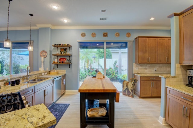 kitchen with sink, light hardwood / wood-style flooring, light stone counters, decorative backsplash, and stainless steel dishwasher