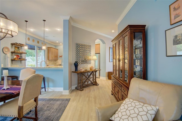 interior space featuring ornamental molding and light wood-type flooring