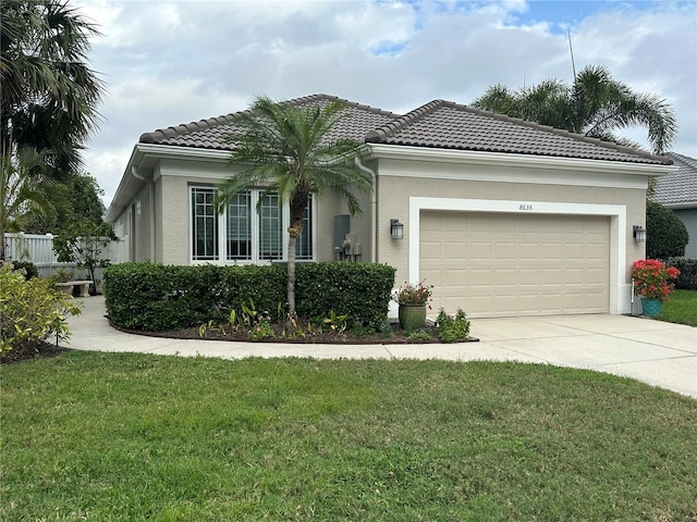 view of front of house with a front yard and a garage