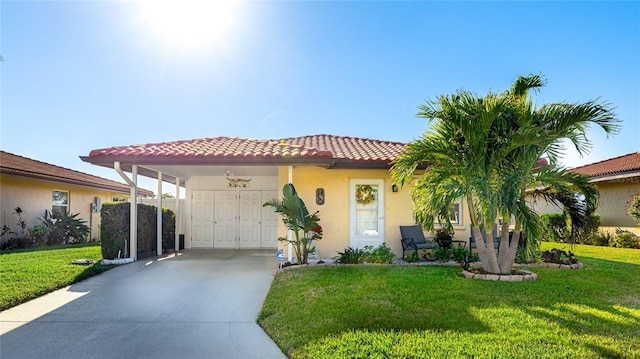 mediterranean / spanish home featuring a carport and a front yard