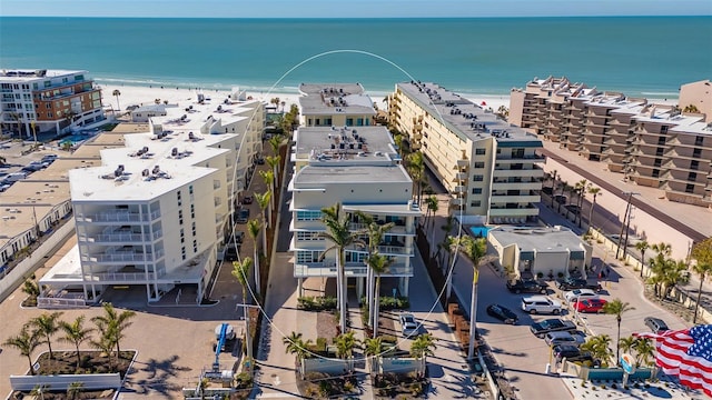 aerial view with a water view and a beach view