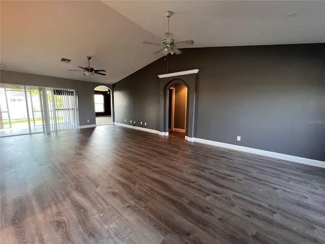 unfurnished living room featuring vaulted ceiling, dark wood-type flooring, and ceiling fan