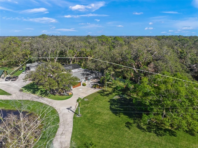 drone / aerial view featuring a wooded view