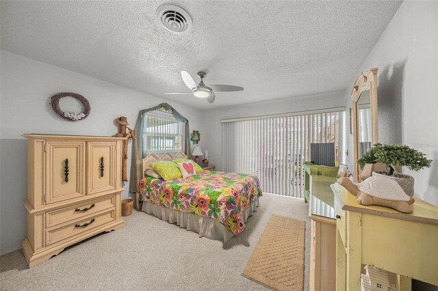 bedroom with light carpet, access to exterior, ceiling fan, and visible vents