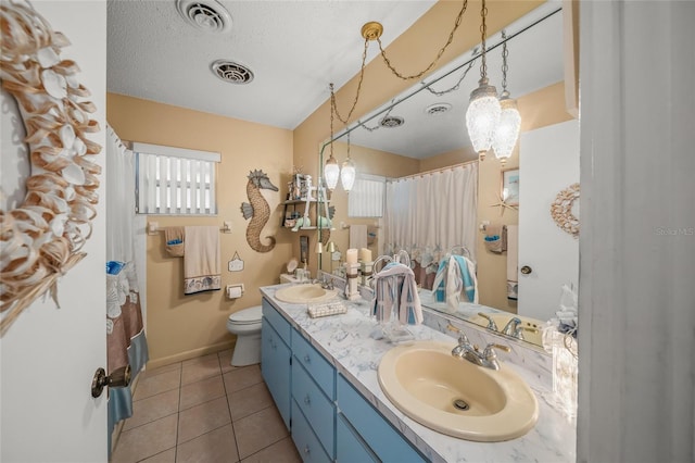 bathroom with tile patterned flooring, visible vents, and a sink