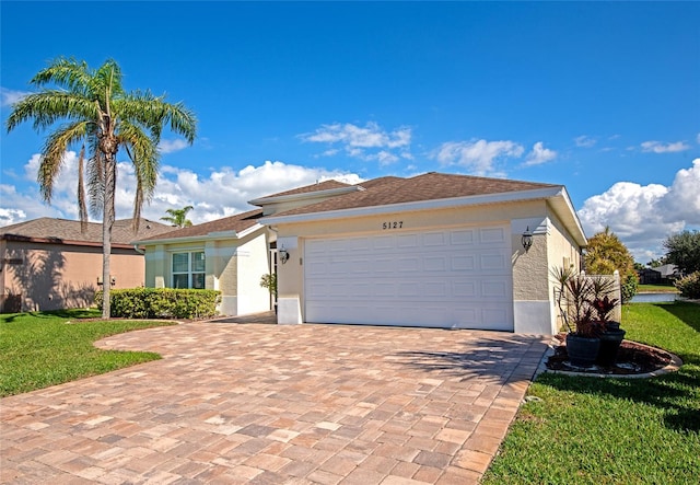 view of front facade with a garage and a front yard