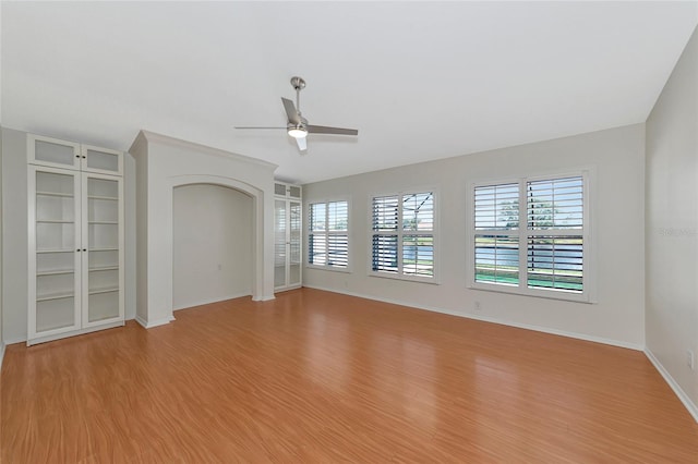 unfurnished living room with ceiling fan and light hardwood / wood-style flooring