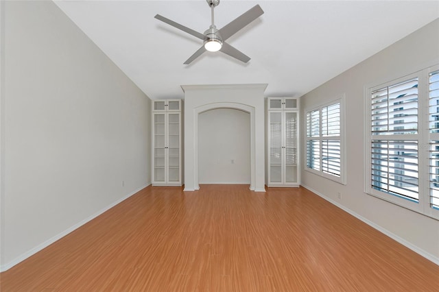 empty room with light hardwood / wood-style floors and ceiling fan