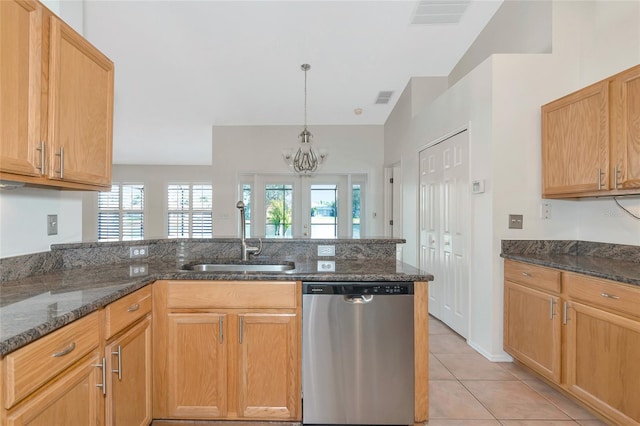 kitchen with dark stone counters, dishwasher, sink, and plenty of natural light