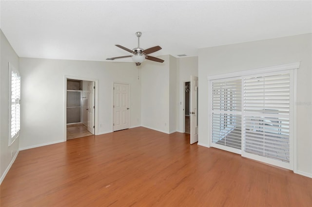 empty room with wood-type flooring, lofted ceiling, and ceiling fan