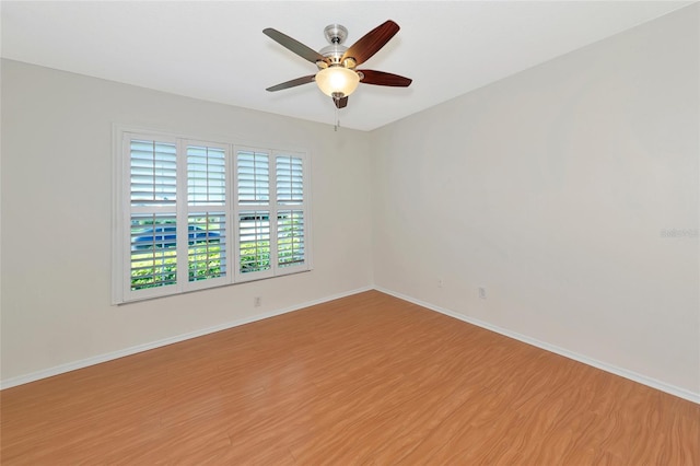 spare room with ceiling fan and wood-type flooring