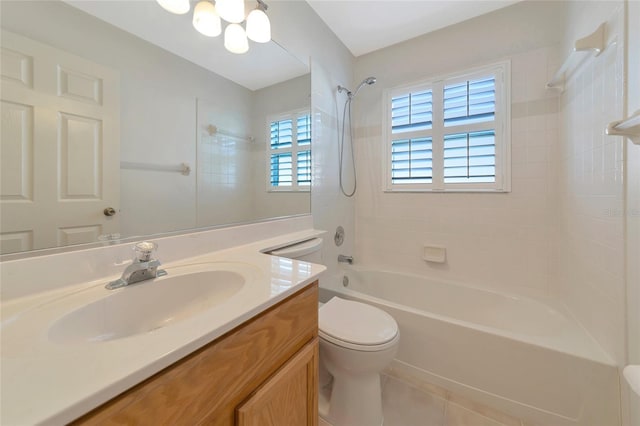 full bathroom with tiled shower / bath, vanity, tile patterned floors, and toilet