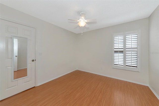 empty room featuring hardwood / wood-style floors and ceiling fan