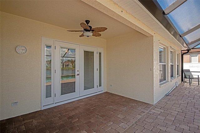 view of patio / terrace featuring ceiling fan and french doors