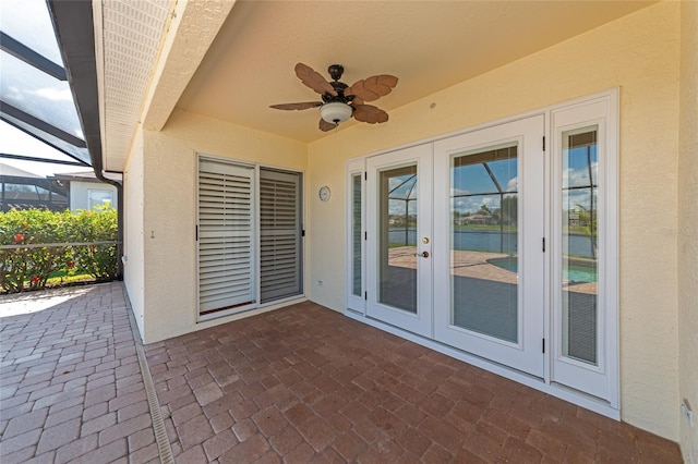 view of patio featuring a lanai, ceiling fan, and french doors