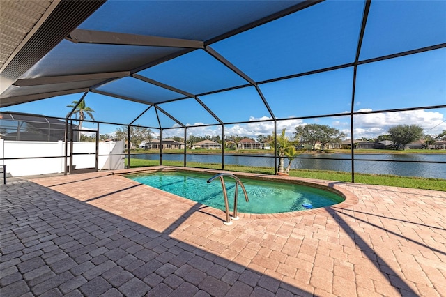 view of pool featuring a patio area, a water view, and glass enclosure