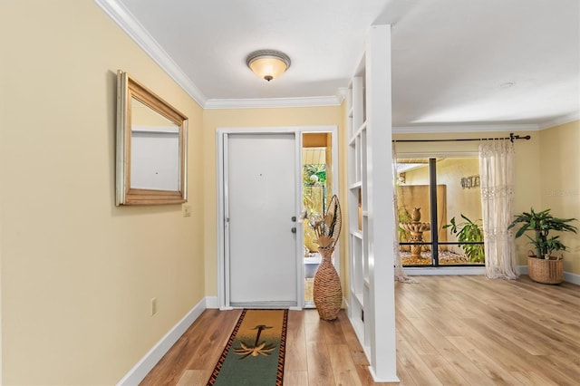 entrance foyer featuring crown molding and light hardwood / wood-style floors