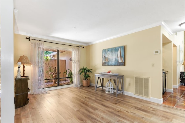 unfurnished room with hardwood / wood-style floors and crown molding