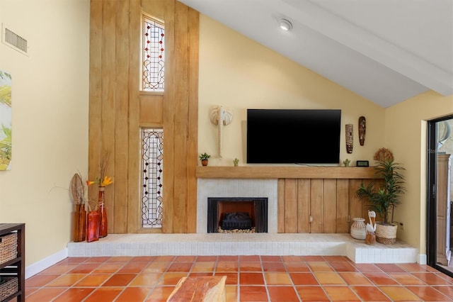 tiled living room with a fireplace, high vaulted ceiling, and beam ceiling