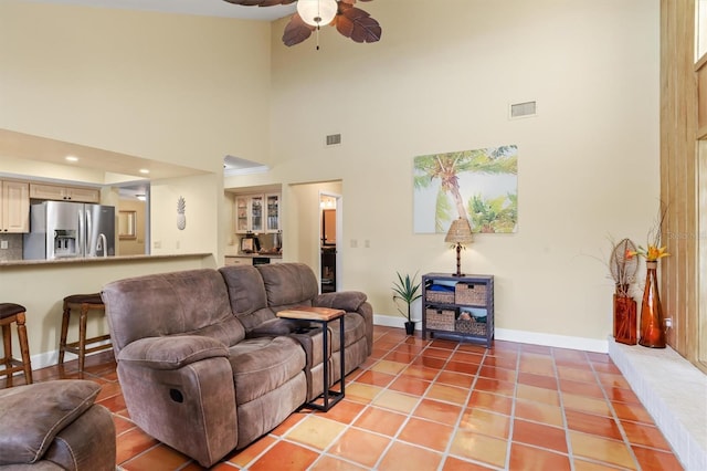 living room featuring light tile patterned flooring and ceiling fan