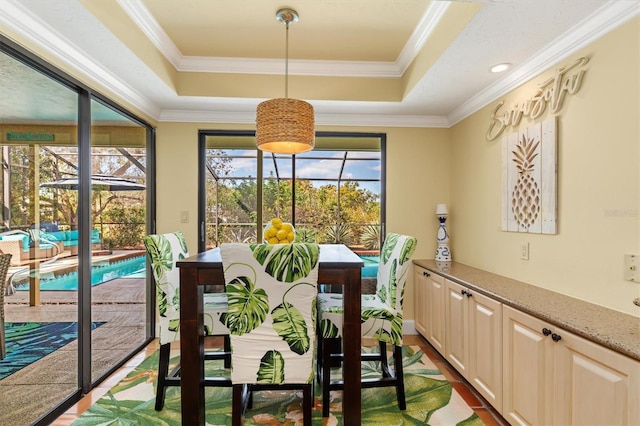 dining area with crown molding, a tray ceiling, and dark hardwood / wood-style flooring