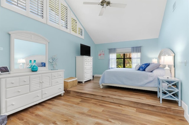 bedroom with high vaulted ceiling, light hardwood / wood-style floors, and ceiling fan