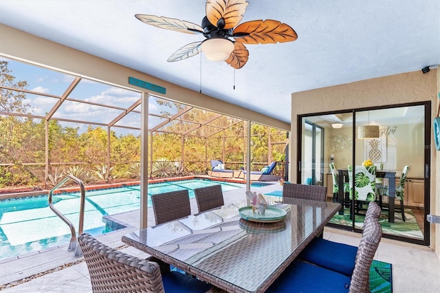 sunroom / solarium with a pool and ceiling fan