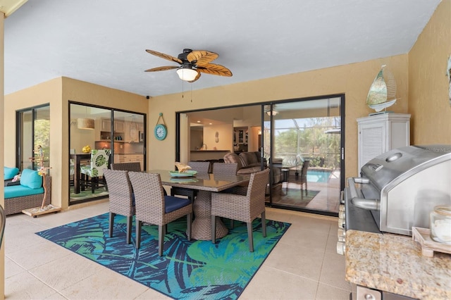 dining space with light tile patterned floors and ceiling fan