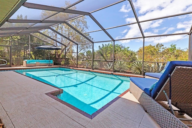 view of swimming pool featuring an outdoor living space, a lanai, and a patio area