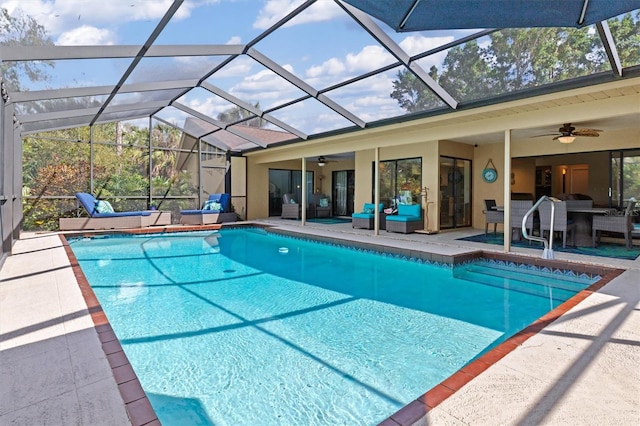 view of pool featuring ceiling fan, an outdoor living space, a lanai, and a patio