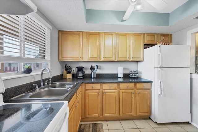 kitchen with white refrigerator, light tile patterned flooring, stove, and ceiling fan