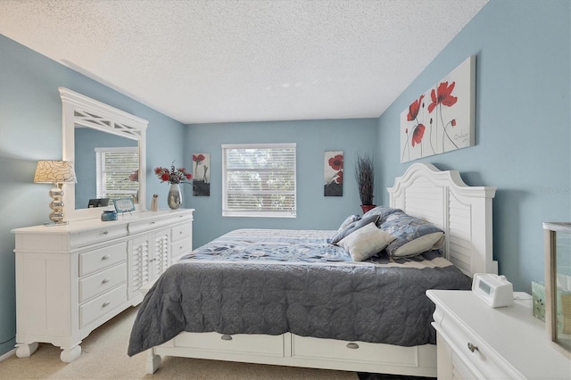 bedroom with light carpet and a textured ceiling