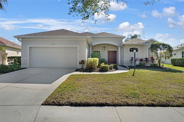 ranch-style house with a garage and a front lawn