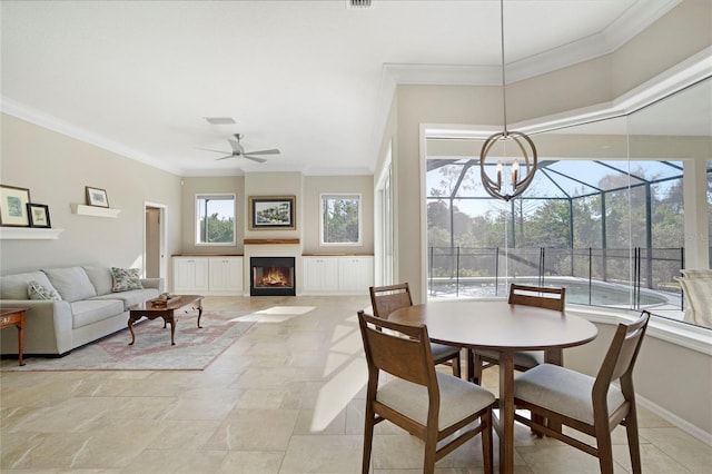 dining area featuring ornamental molding and ceiling fan with notable chandelier