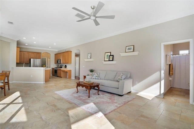 living room featuring crown molding and ceiling fan