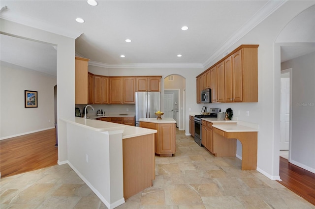 kitchen with ornamental molding, appliances with stainless steel finishes, a center island, and kitchen peninsula